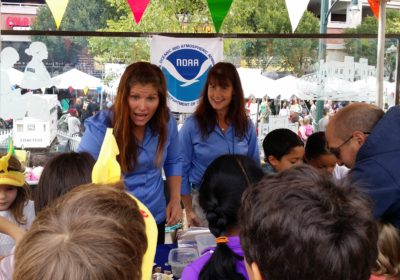 Two women talking with children.