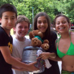 Four children holding a trophy.