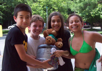 Four children holding a trophy.