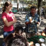 A man and a woman share trawl specimens with students.