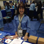 A woman standing in the NOAA booth.