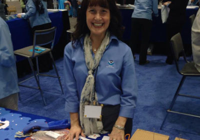 A woman standing in the NOAA booth.