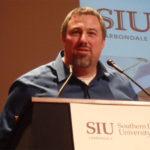 A man stands at a podium at Southern Illinois University