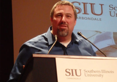 A man stands at a podium at Southern Illinois University