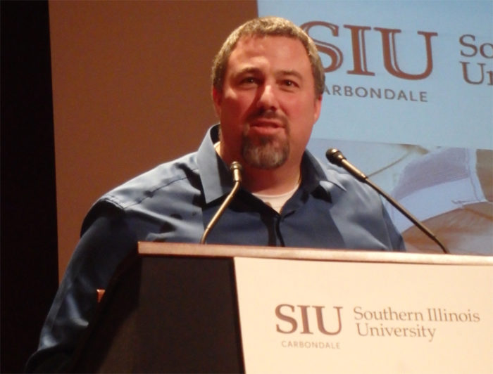 A man stands at a podium at Southern Illinois University