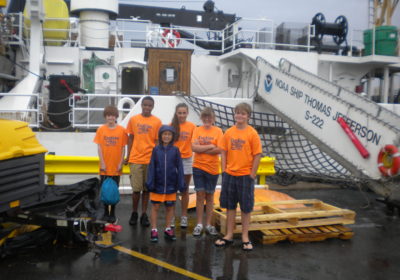 Student campers stand in front of the NOAA ship Thomas Jefferson.
