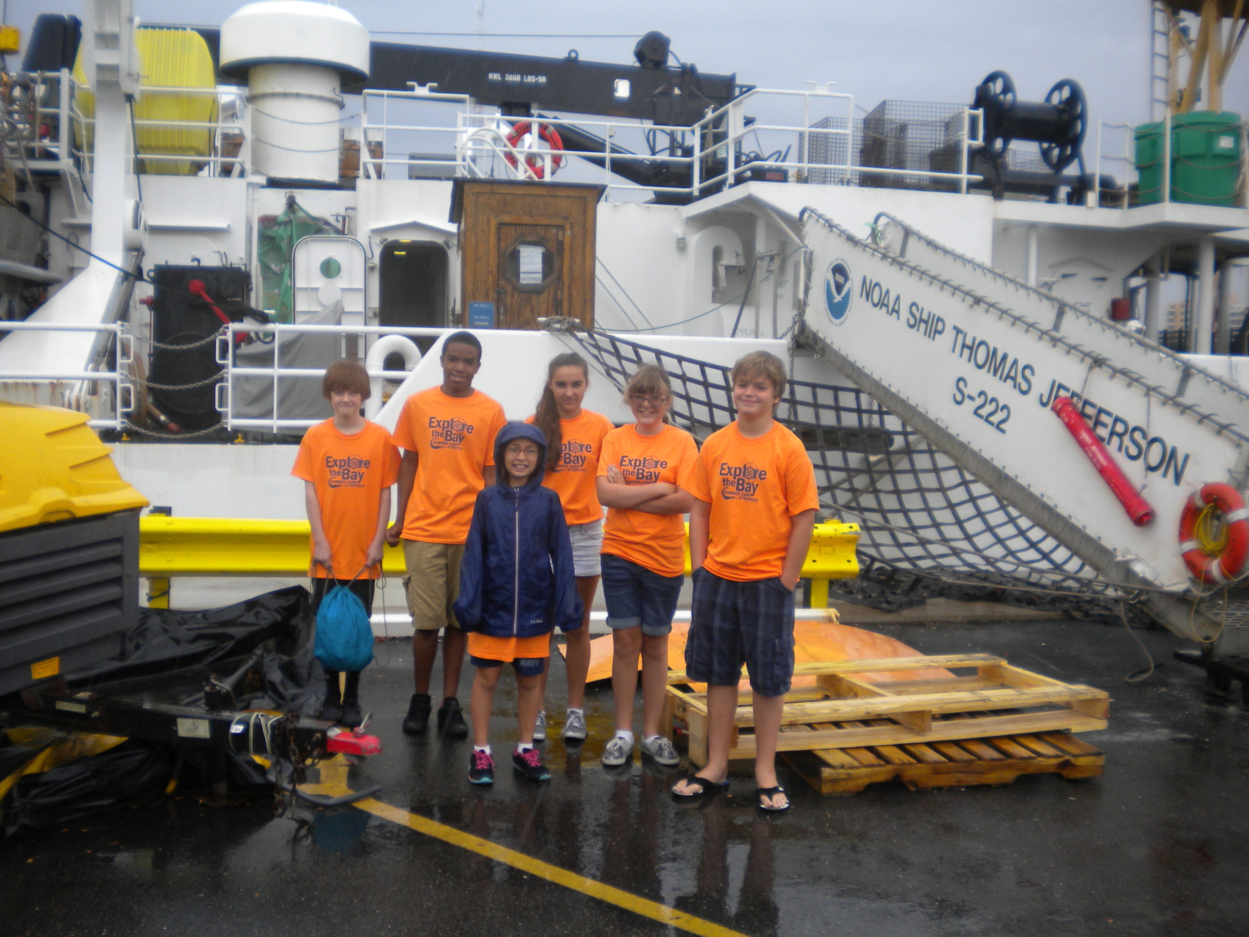 Student campers stand in front of the NOAA ship Thomas Jefferson.