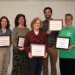 Five people standing holding awards.