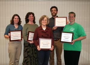 Five people standing holding awards.