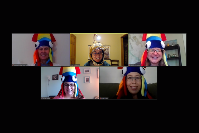A group of people in a Zoom meeting and they are all wearing different marine animal hats.