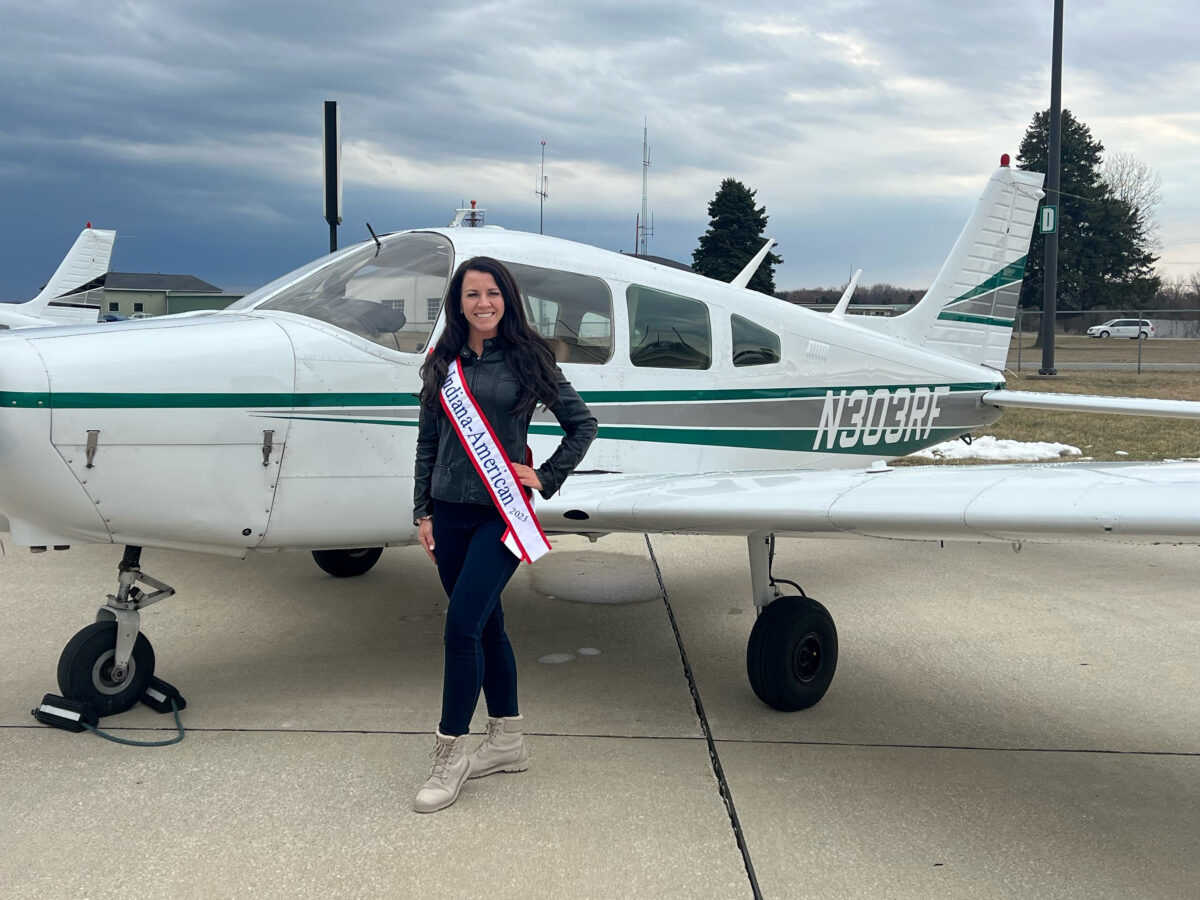 Ashley Cosme Mrs Indiana-American 2023 in front of small plane
