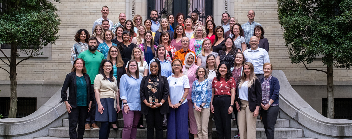 Cohort of National Geographic Society's 2023 Grosvenor Teacher Fellows standing on front steps of a building