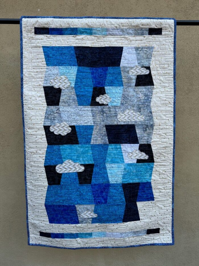 Quilt portraying the okta scale in blocks of color ranging from gray to blue to black