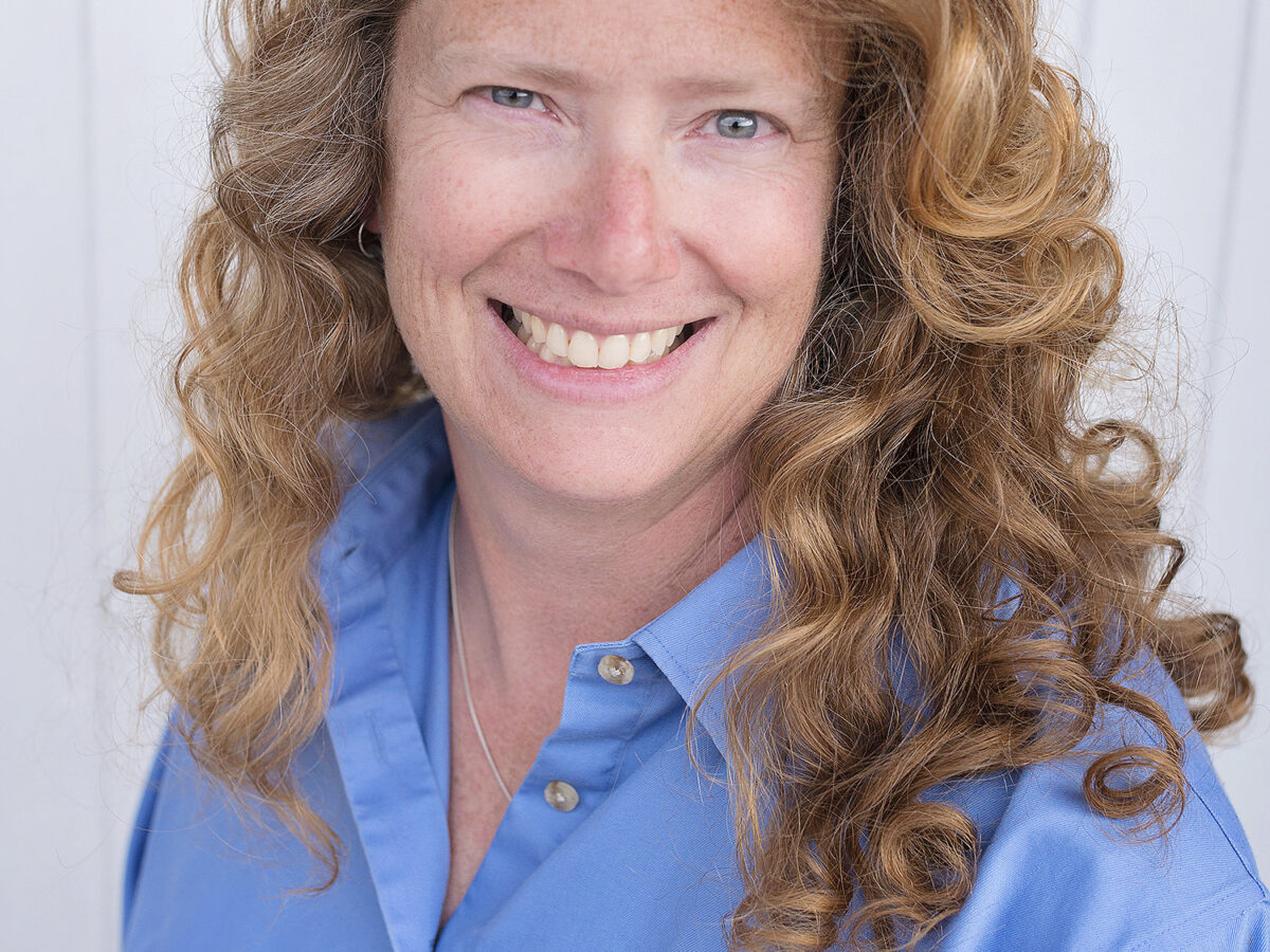 profile picture of a woman with long strawberry blond hair wearing a blue shirt