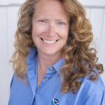 profile picture of a woman with long strawberry blond hair wearing a blue shirt