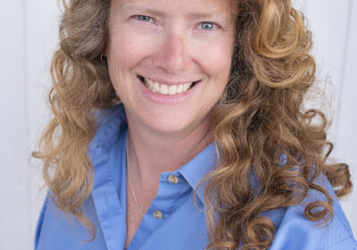 profile picture of a woman with long strawberry blond hair wearing a blue shirt
