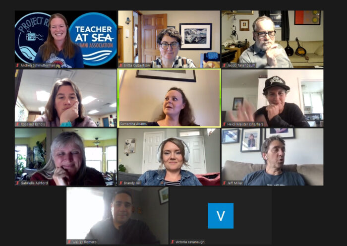 A virtual meeting screen showing nine participants: some are smiling, waving, or talking, while a tenth participant, represented by a blue tile with a white letter "v", joins without video.