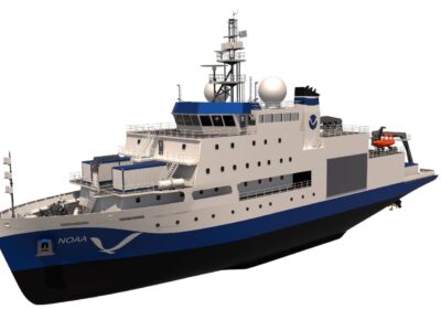 A digital rendering of a NOAA research vessel with a blue and white color scheme. The ship features multiple decks, satellite domes, and equipment. It has "NOAA" and a logo printed on the side. The background is clear white.